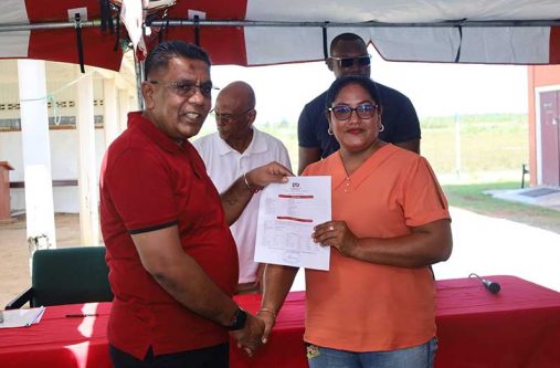Minister of Agriculture Zulfikar Mustapha distributes a certificate of title to a farmer under the government’s rice-insurance programme