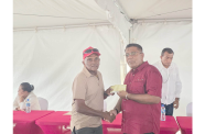 Minister of Agriculture Zulfikar Mustapha handing over a cheque to a rice farmer