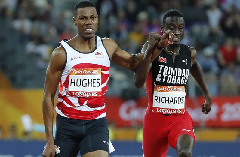 Trinidadian Jereem Richards (right) clashes arms across lanes with Zharnel Hughes in the dying stages of a frenetic 200 metres yesterday.