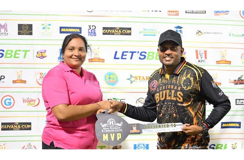 Richie Looknauth collects a ceremonial key for his brand new motorcycle from a representative of Regal Supercentre