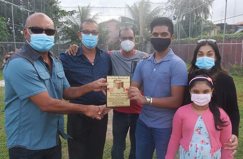 GFSCA’s Rickey Deonarine (left) hands over the plaque to the late Husein’s son Reyad. Others in picture, from left, are Jailall Deodass, Ramesh Sunich, wife Samantha and daughter Sarah.