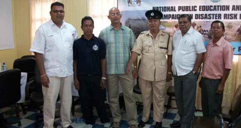 At the Bartica disaster awareness campaign are, from left: "F" One  Division  Community  Policing  Group’s Chairman, Mr. Edward  A Persaud;   NCPE  Public  Relations  Officer, Mr  Roy  Prince; Vice-Chairman, "F"  One  Division  Community  Policing; CDC Deputy  Director, Colonel Francis  Abraham; Officer  in  Charge of the Bartica  Police  Station, Sub-Division  Number Two; "F"  Division ASP, Mr. R . Banwarie; CDC Director-General, Colonel  (retired)  Chabilall  Ramsarup, MSM;  and 'F'  One Division  Community  Policing’s Assistant  Secretary/Treasurer, Mr.  Rodney  Smith  