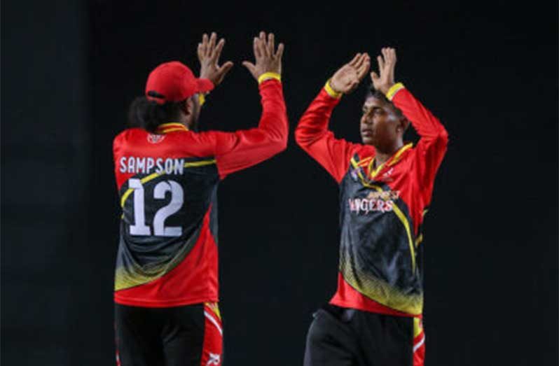 Riyad Latiff of the Guyana Rainforest Rangers ((right) celebrates one of his four wickets against the Leeward Islands Thunder. (Photo by Daniel Prentice/CWI)
