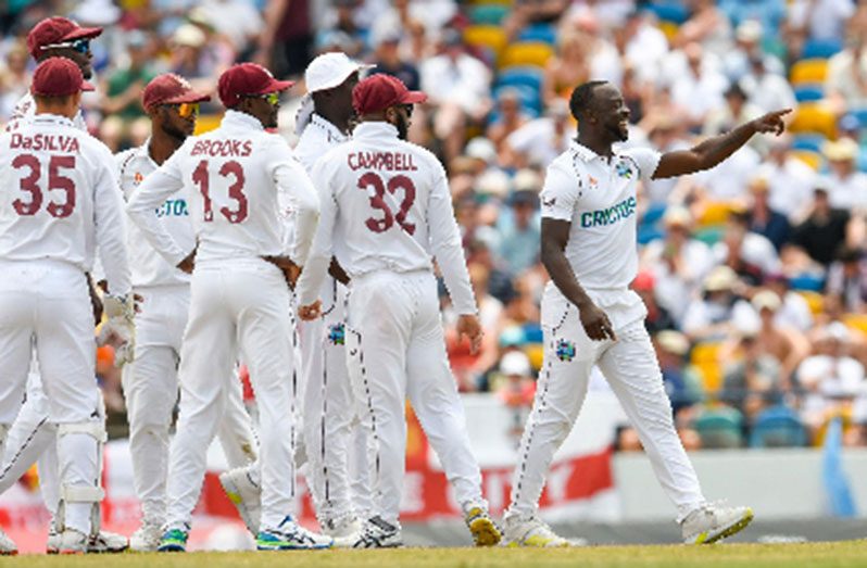 Kemar Roach (right) celebrates after removing England captain Joe Root to move to seventh on the West Indies all-time list of wicket-takers (Photo courtesy CWI Media)