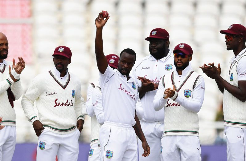 Kemar Roach celebrates reaching his 200th wicket in Tests on the second day of the Old Trafford third Test.