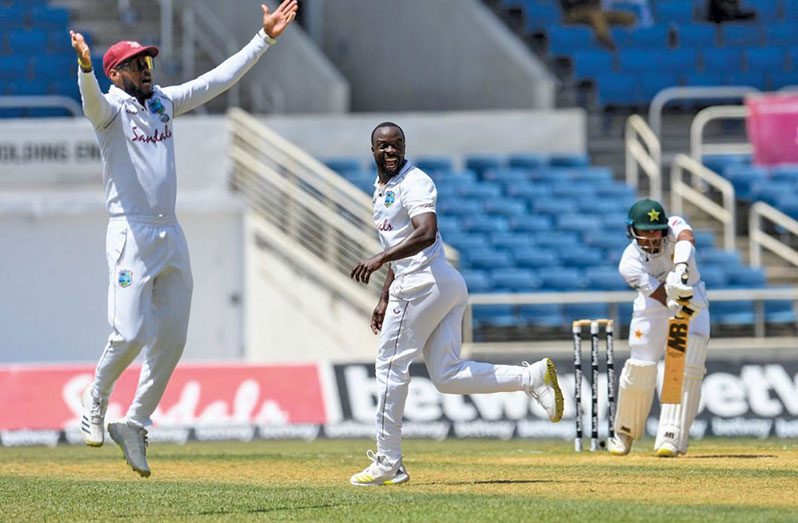 Kemar Roach (centre) and Kraigg Brathwaite appeal in the first Test.