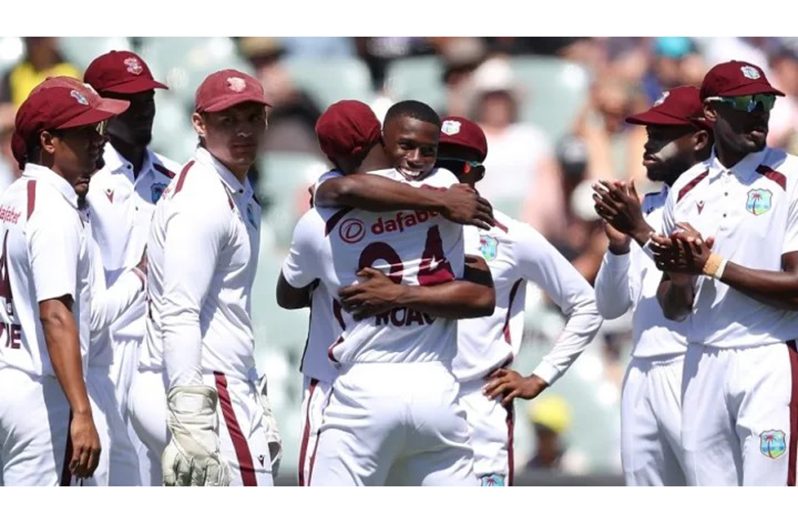 Kemar Roach (left) celebrates a wicket with Shamar Joseph during the opening Test in Adelaide.