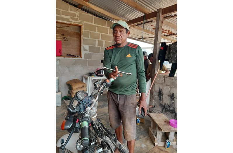 Robert Jacobis doing what he does best, working on a motorcycle
