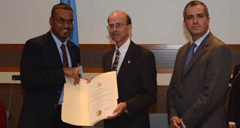Minister Robert Persaud presenting Guyana's ratification documents to the UN