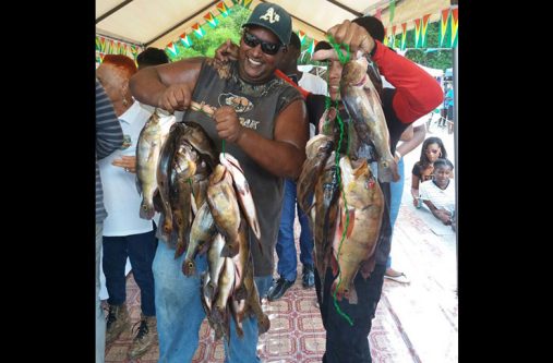 Ravi Persaud (left) of Amelia’s Ward, who had the largest single catch of the day. With him, at right, is boat captain, Ray Peters from Rockstone, who took him to the Essequibo River to make the catch