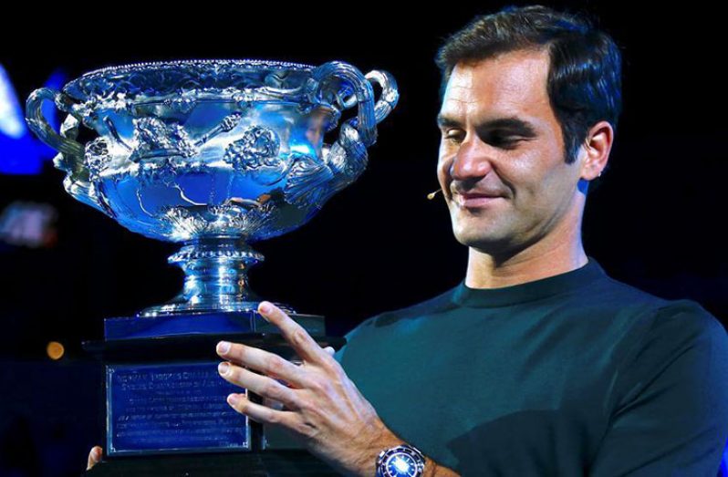 Switzerland's Roger Federer holds the Men's singles trophy as he participates in the official draw ceremony in Melbourne Australia, ahead of the Australian Open tennis tournament. (REUTERS/David Gray)