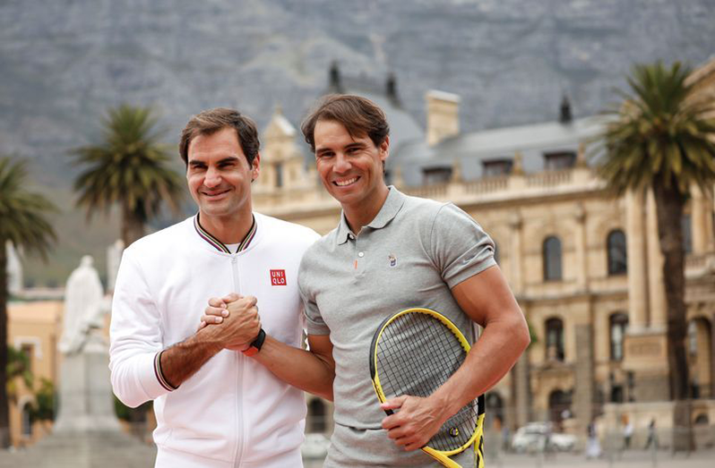 Roger Federer and Rafael Nadal pose for photographers ahead of their "Match in Africa" exhibition tennis match in Cape Town.