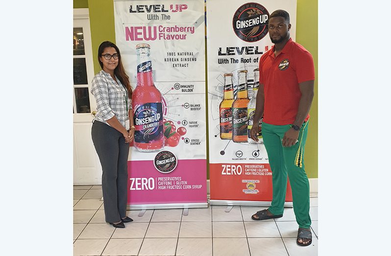 Romario Shepherd and Brand Manager Gabriell Lopes stop for a photo opportunity after their contract-signing.