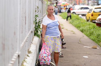 Romona Barak-Oada, also known as Romona Soman, with her worldly belongings on the pavement outside the Bourda Post Office (Samuel Maughn photo )