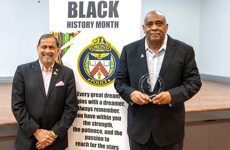 Ron Fanfair, right, with Honorary Consul Mani Singh, poses with his award