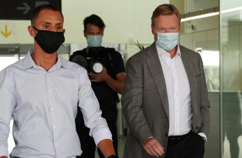 Ronald Koeman (right) arrived at Barcelona's El Prat airport on Tuesday.