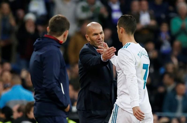 Real Madrid coach Zinedine Zidane shakes hands with Cristiano Ronaldo as he is substituted off. (REUTERS/Javier Barbancho)