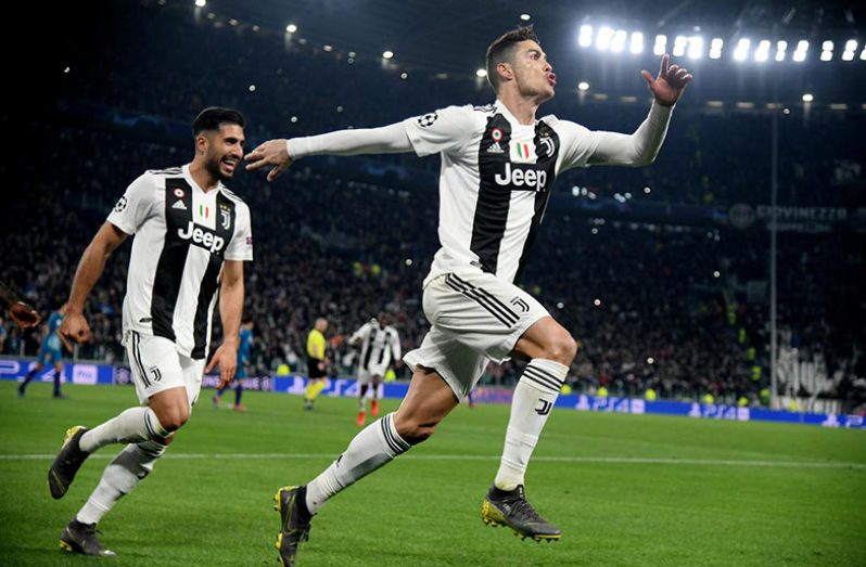 Juventus' Cristiano Ronaldo celebrates scoring their third goal to complete his hat-trick with Emre Can (REUTERS/Alberto Lingria)