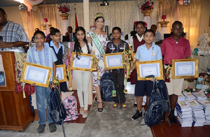 Seven of the Awardees pose with Ms. World Guyana, Vena Mookram after the presentation