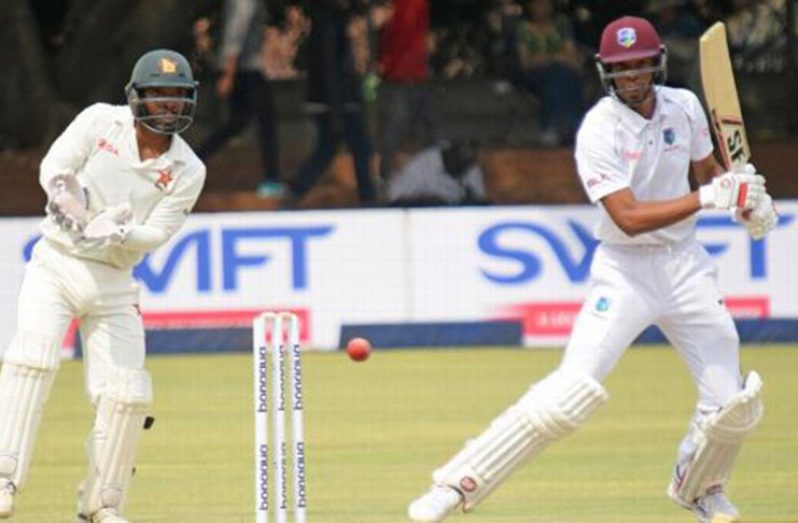 Zimabawe wicketkeeper Regis Chakabva checks out Roston Chase's punch  during his unbeaten  91 in Bulawayo. (Getty Images)