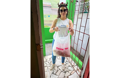 President of the Rotary Club of Demerara, Cameron Domanique, delivers breakfast of bake and saltfish to residents of Archer’s and Byer’s Senior Citizens’ Homes early in the morning, ahead of their 7:30 a.m. mealtime, before the club began decorating for the holidays