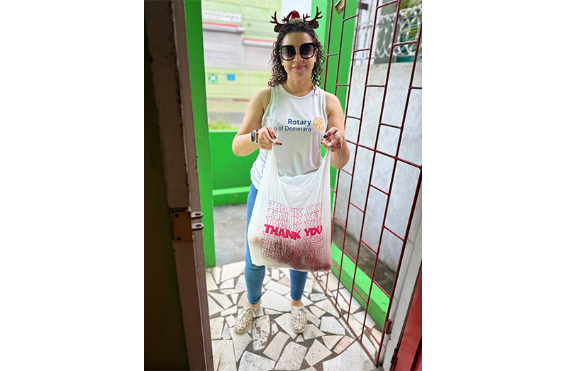 President of the Rotary Club of Demerara, Cameron Domanique, delivers breakfast of bake and saltfish to residents of Archer’s and Byer’s Senior Citizens’ Homes early in the morning, ahead of their 7:30 a.m. mealtime, before the club began decorating for the holidays