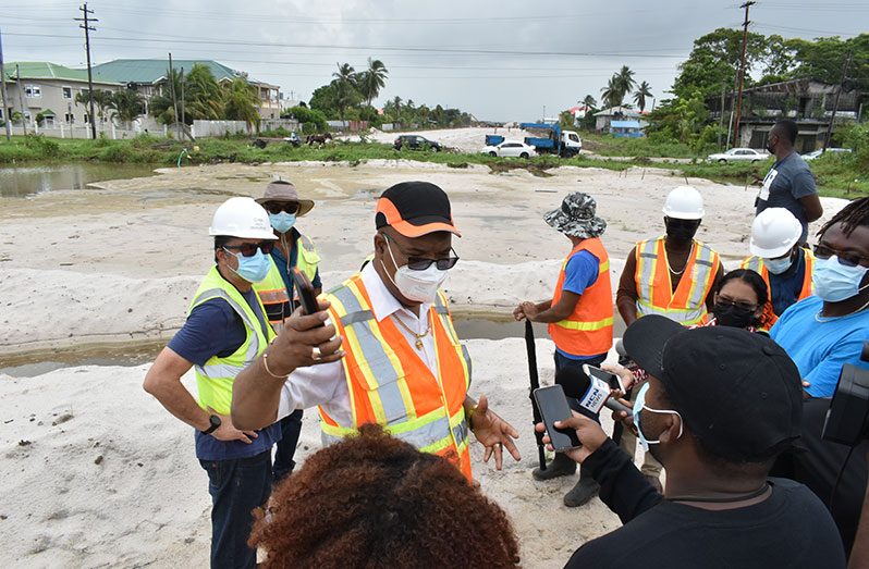 Minister of Public Works, Juan Edghill, engaging the media at the site proposed for the roundabout that will connect the Mandela Four Lane Highway with the Eccles Four Lane Highway (Elvin Croker photo)