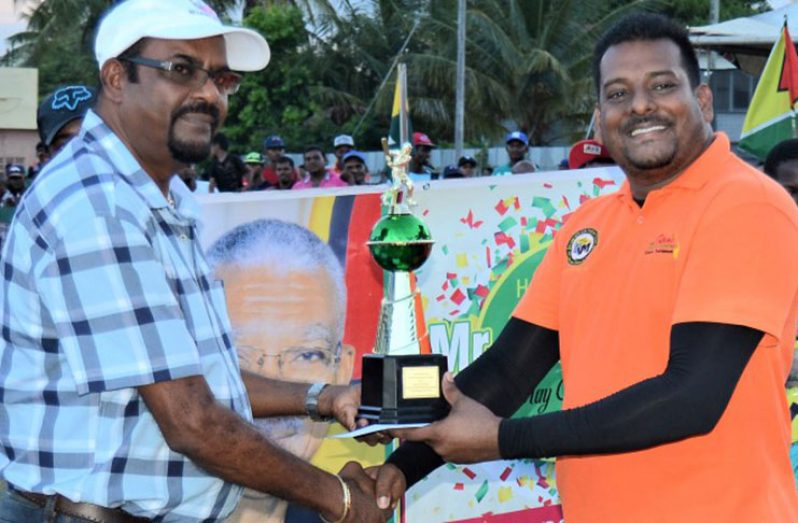Roy Jaferally receives his Man-of-the-Final trophy from Mahadeo Panchu of KSM Investment.