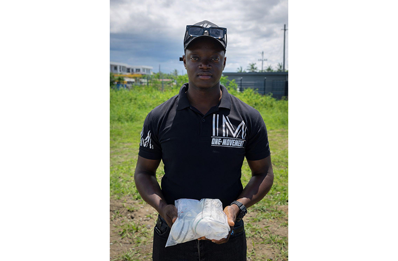 Organiser Royale Melville displays the box of cricket balls