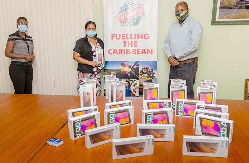 Joylyn Johnson, Retail Accounts Executive, Rubis, at the presentation of the tablets to Headmistress of Diamond Primary School, Sherron Howard, along with Lance Hinds, Managing Director of BrainStreet.