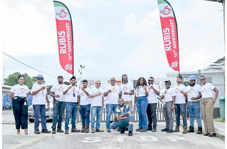 Members of team RUBIS Guyana raise a toast to 15 years of success in the Ramsburg Terminal Office