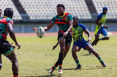 Guyana's winger Tyreese Prescod (with ball in hand) making a pass against the Barbados defence