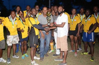 Golden Brook representative Dustani Barrow presents the winner’s trophy to Yamaha Caribs Captain Akeem Fraser, while other sponsors and players look on.
Photo Name: Rugby Presentation