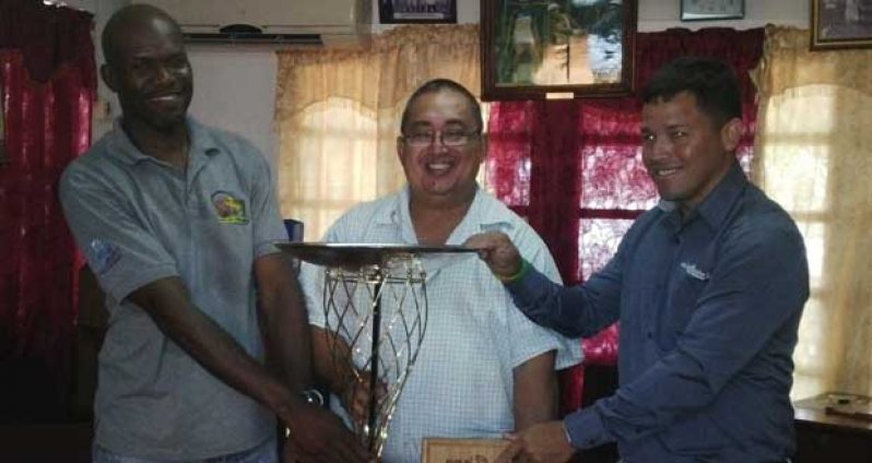 Team manager Kenneth Grant-Stewart, GRFU president Peter Green and team captain Ryan Gonsalves pose with the NACRA 15s Trophy which they won by defeating the USA South 30-27 last Saturday in Atlanta.