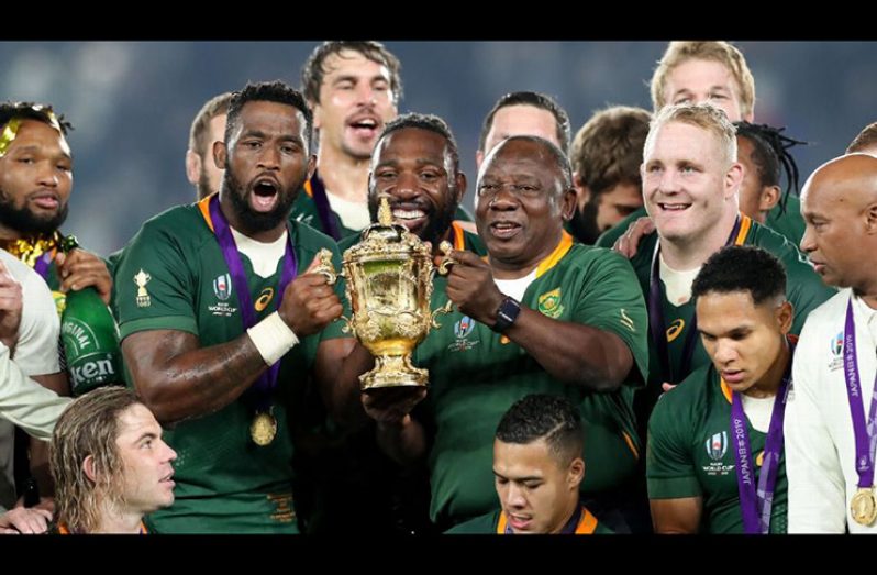 Siya Kolisi, left, the first black South African rugby captain, holds the Rugby World Cup trophy with South Africa president Cyril Ramaphosa.( Juan Jose Gasparini/Gallo Images/Getty Images)