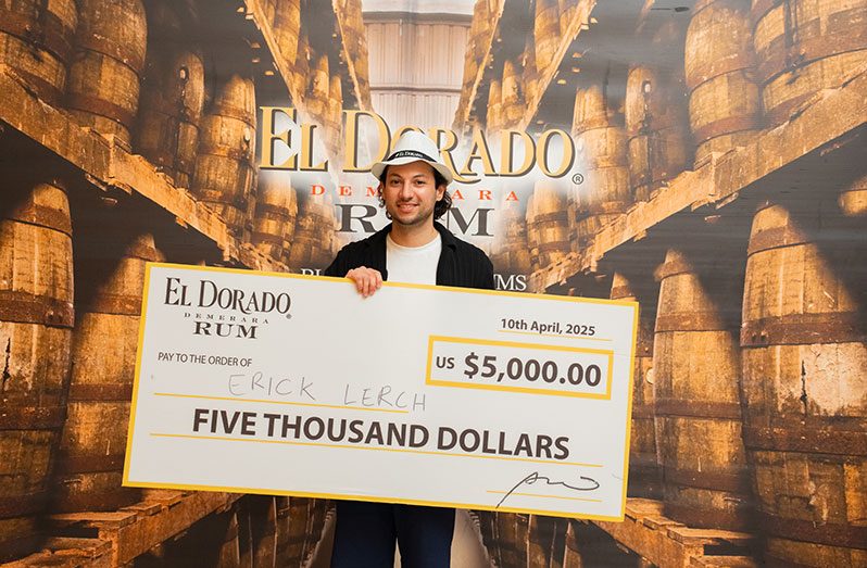 First Place Winner of the El Dorado Rum Heritage Cocktail Competition 2025, Erick Lerch, with cheque