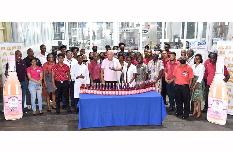 Rum factory staff with the winning product (Banks DIH photo)