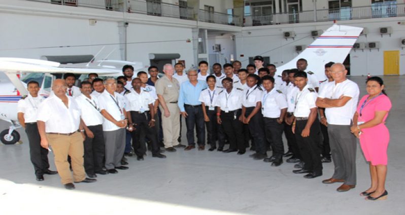 Education Minister Dr Rupert Roopnaraine with staffers at the Art Williams & Harry Wendt Aeronautical Engineering School