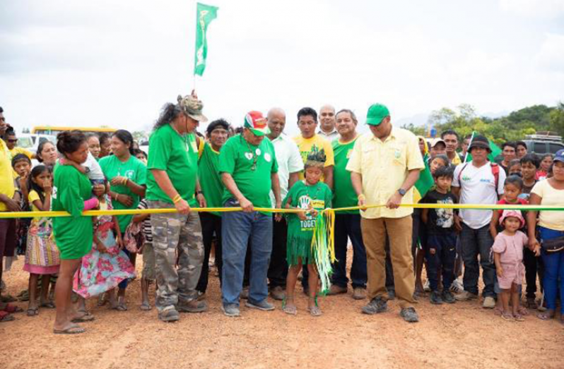 Priya Leonard of Hiawa Village cutting the ribbon in the presence of Minister of Indigenous Peoples' Affairs, Sydney Allicock; and Minister of Natural Resources, Raphael Trotman, and Ministerial Adviser, Mervyn Williams