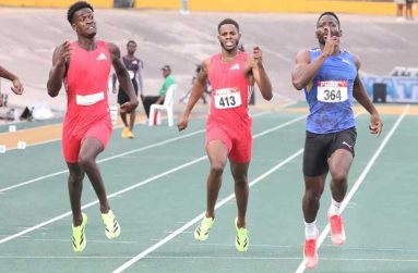 Rusheen McDonald (right) romps to victory in the men’s 400 metres.