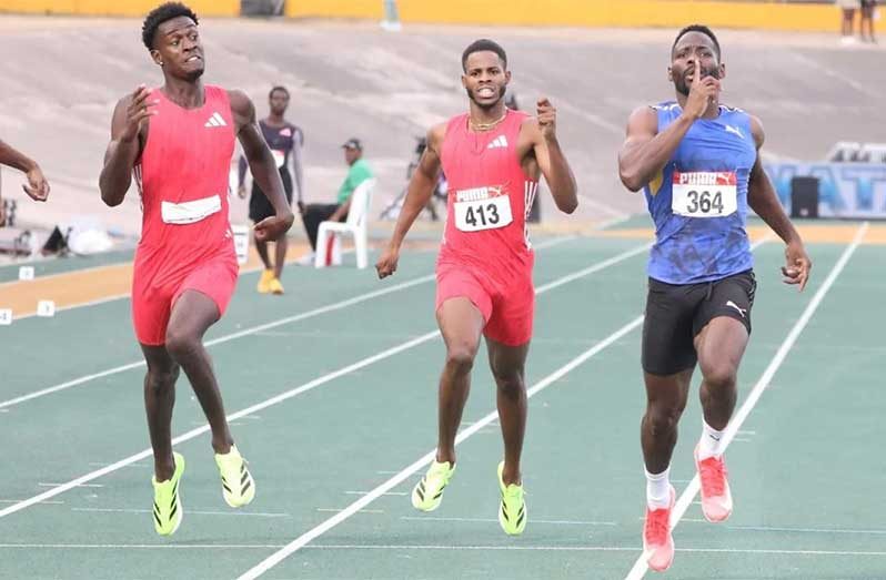 Rusheen McDonald (right) romps to victory in the men’s 400 metres.