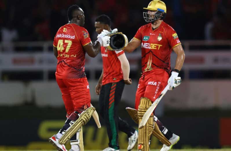 Tim David (right) and Andre Russell of TKR celebrate victory during the Men's 2024 Republic Bank Caribbean Premier League match between TKR and Guyana Amazon Warriors at Queen's Park Oval (Photo by Ashley Allen - CPL T20/CPL T20 via Getty Images)