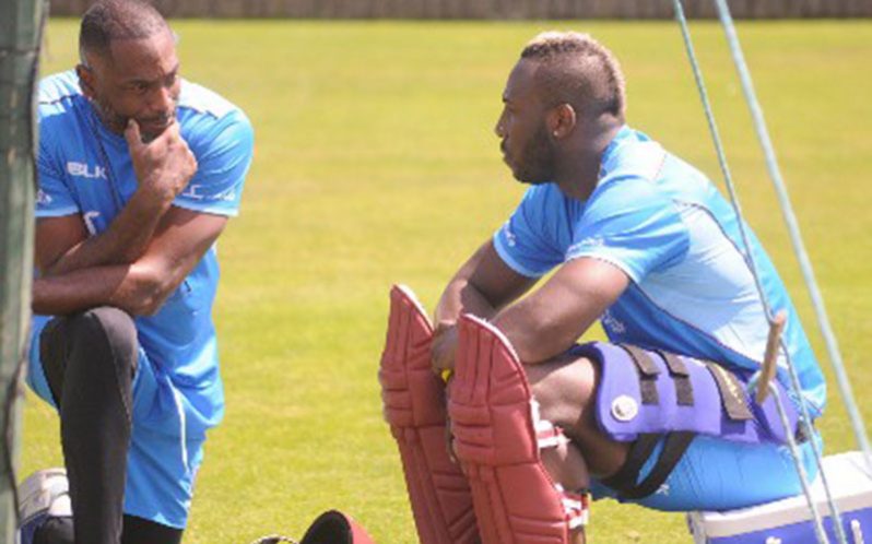 Andre Russell (right) chats with head coach Floyd Reifer during a recent net session.