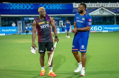 IN HAPPIER TIMES: KKR’s Andre Russell shares a joke with Mumbai’s Kieron Pollard during the tournament.