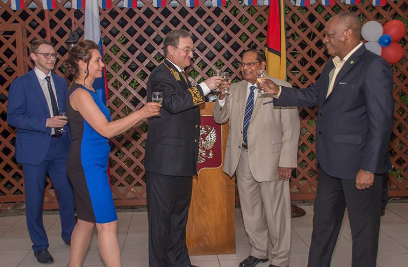 Prime Minister Moses Nagamootoo, who is performing the duties of President, shares a toast along with Russian Ambassador to Guyana, Nicolay Smirnov, as Minister of State Joseph Harmon and others look on