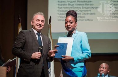 Tenesha Jerry-Ann Les Flores receiving her certificate on graduation day in Russia