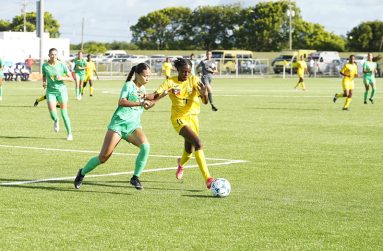 Lady Jags defender Rylee Traicoff, holding off the Benna Girls’ Kevoncia James during their W Gold Cup qualifier.