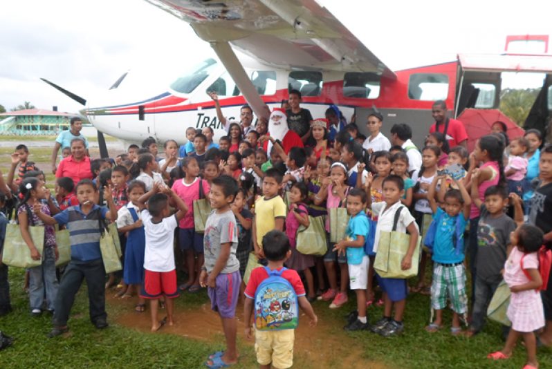 Kamarang children pose with Santa and his entourage before he departed for Georgetown (Photos by Shirley Thomas)