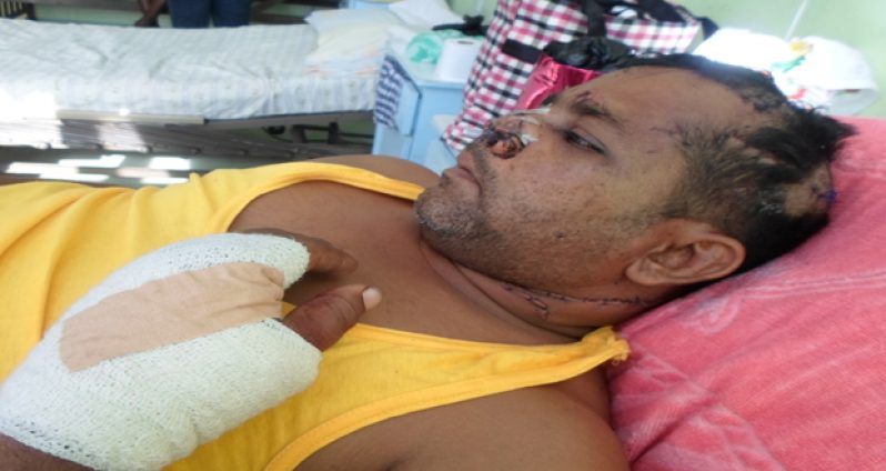 The badly wounded Karran Persaud on a hospital bed