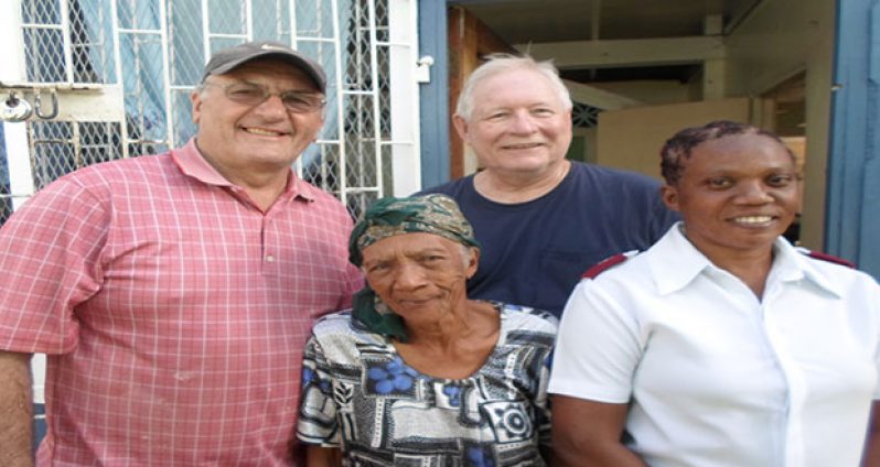 Two of the volunteers pose with Auxiliary Captain, Leba Hayling in charge of the facility, and second oldest tenant, Ms. Edith King, 83